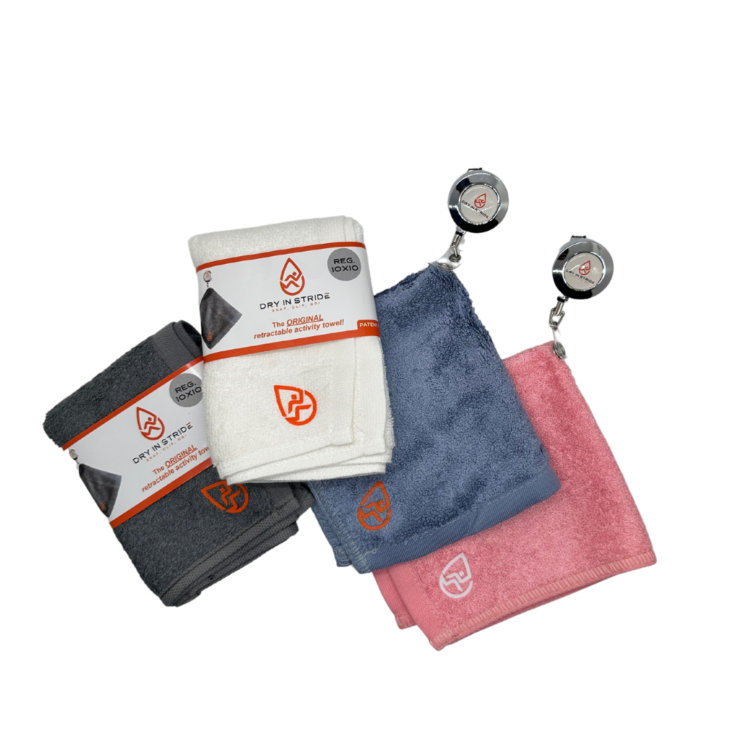 Set of four Dry in Stride towel sets in gray, white, blue, and pink with a retractable clip on a white background.